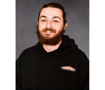 SERVPRO employee in front of grey background